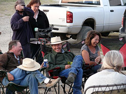 Gary, Shayne and Jo-Anne laughing with Chris Clements and Julie Goldman filming from behind